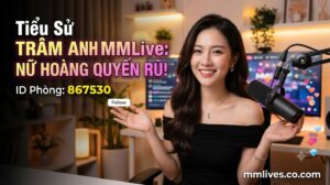Banner hồ sơ idol Trâm Anh MMLive, giới thiệu 'Nữ hoàng quyến rũ!' với ID phòng 867530. Hình ảnh một nữ streamer trẻ mỉm cười trước thiết bị livestream, với các biểu tượng trái tim và kim cương bay lên. Bao gồm domain mmlives.co.com.